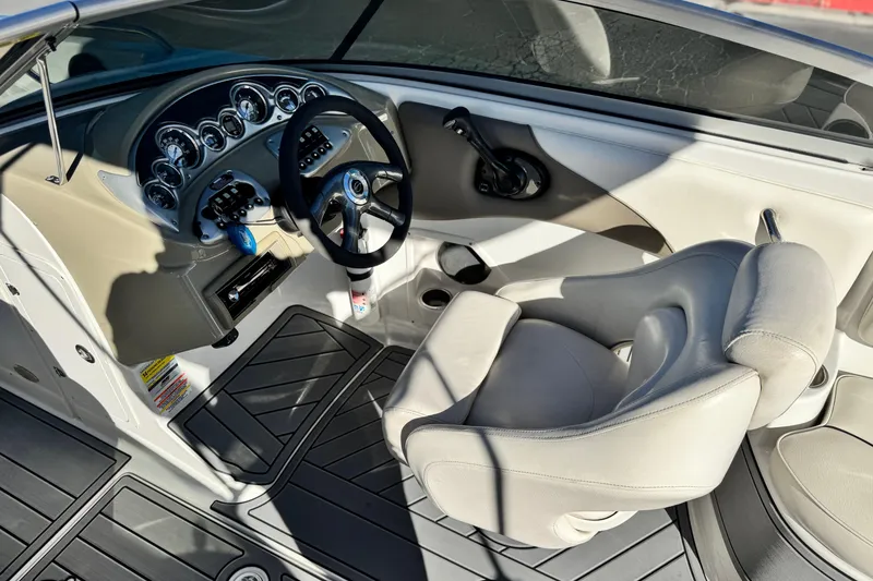 Slide: The Image of 2006 Crownline 260 EX boat cockpit with steering wheel and control panel. - 30