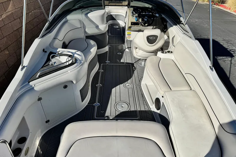 Slide: The Image of 2006 Crownline 260 EX boat interior with spacious seating and modern dashboard. - 7