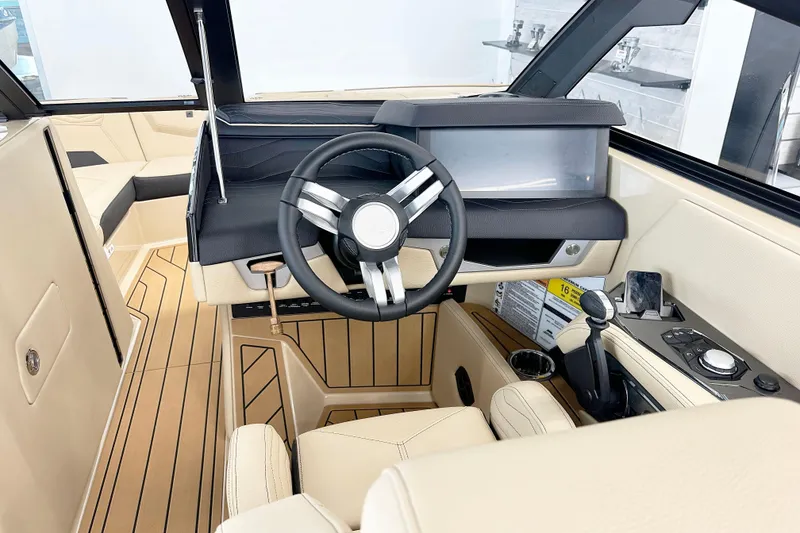 Slide: The Image of Interior of 2025 Nautique Super Air Nautique G23 Paragon boat, featuring modern steering and controls. - 10