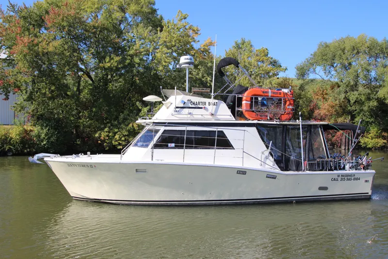 The Image of 1980 Delta Boatworks 34 Offshore charter boat on a calm river, surrounded by trees. - 0
