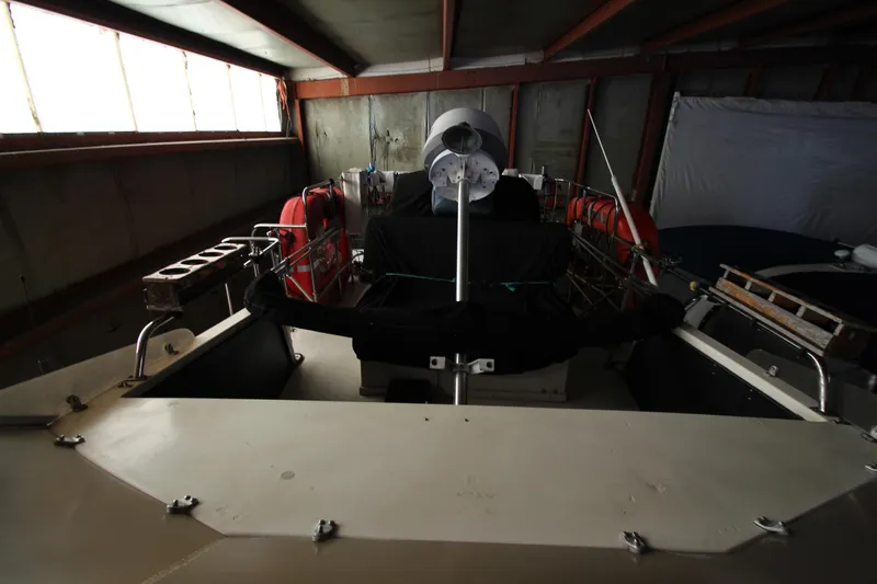 Slide: The Image of 1980 Delta Boatworks 34 Offshore in storage, featuring life rings and equipment. - 12