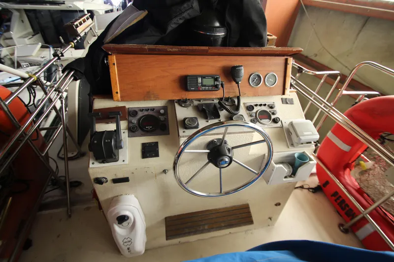 Slide: The Image of 1980 Delta Boatworks 34 Offshore helm with steering wheel and navigation instruments. - 16