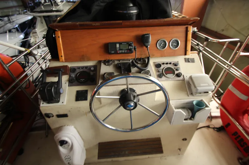 Slide: The Image of Helm of 1980 Delta Boatworks 34 Offshore with steering wheel and navigation instruments. - 17