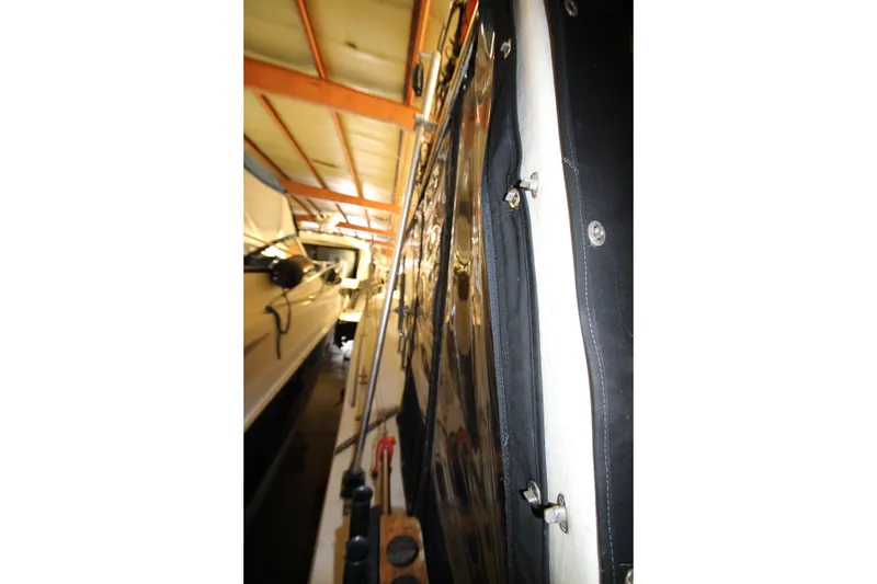 Slide: The Image of 1980 Delta Boatworks 34 Offshore in storage, side view with cover and equipment. - 18