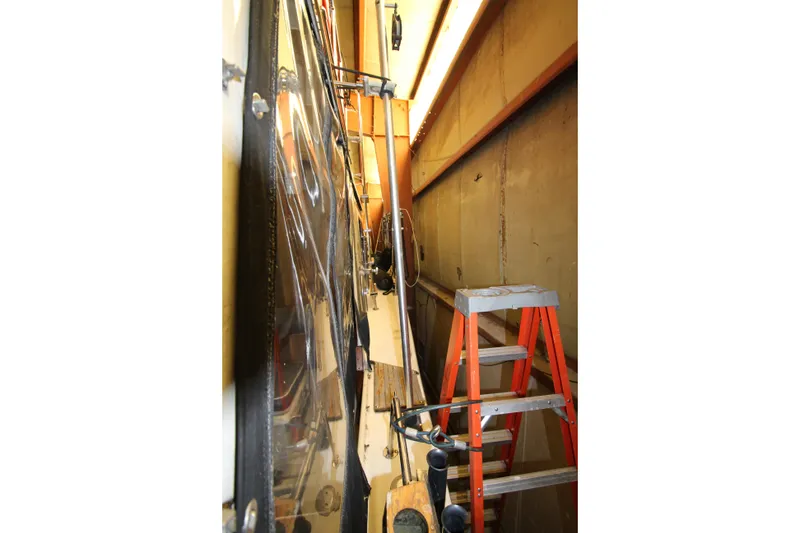 Slide: The Image of 1980 Delta Boatworks 34 Offshore in a narrow storage space with a ladder. - 20