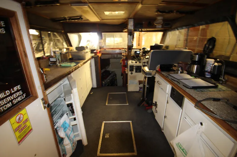 Slide: The Image of Interior of 1980 Delta Boatworks 34 Offshore, featuring kitchen and navigation area. - 21