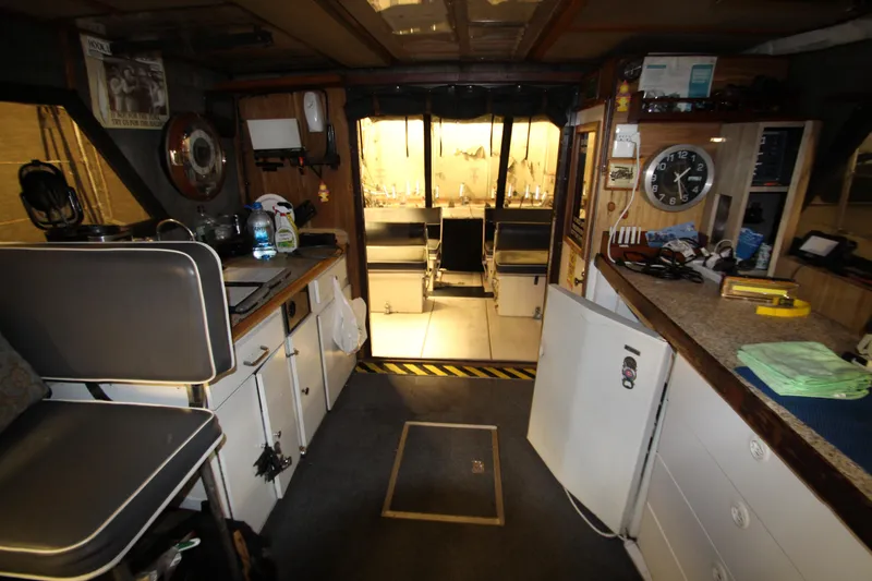 Slide: The Image of Interior of 1980 Delta Boatworks 34 Offshore, featuring kitchen and seating area. - 25