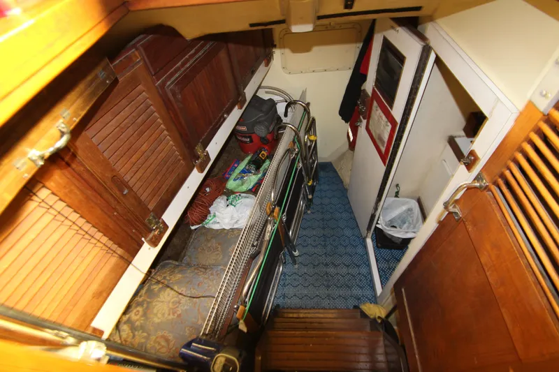 Slide: The Image of Interior of 1980 Delta Boatworks 34 Offshore, featuring wooden cabinets and nautical equipment. - 26