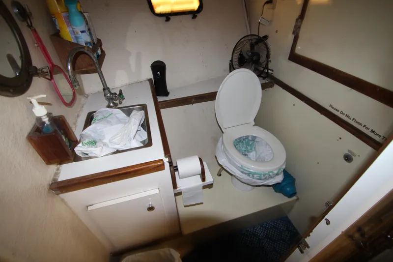 Slide: The Image of Bathroom interior of 1980 Delta Boatworks 34 Offshore, featuring sink and toilet. - 29