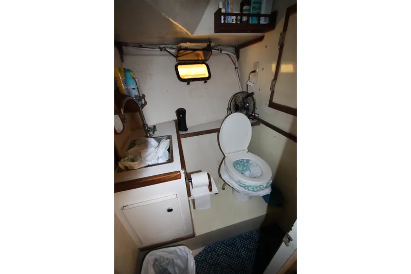 Slide: The Image of 1980 Delta Boatworks 34 Offshore bathroom with sink, toilet, and storage. - 30