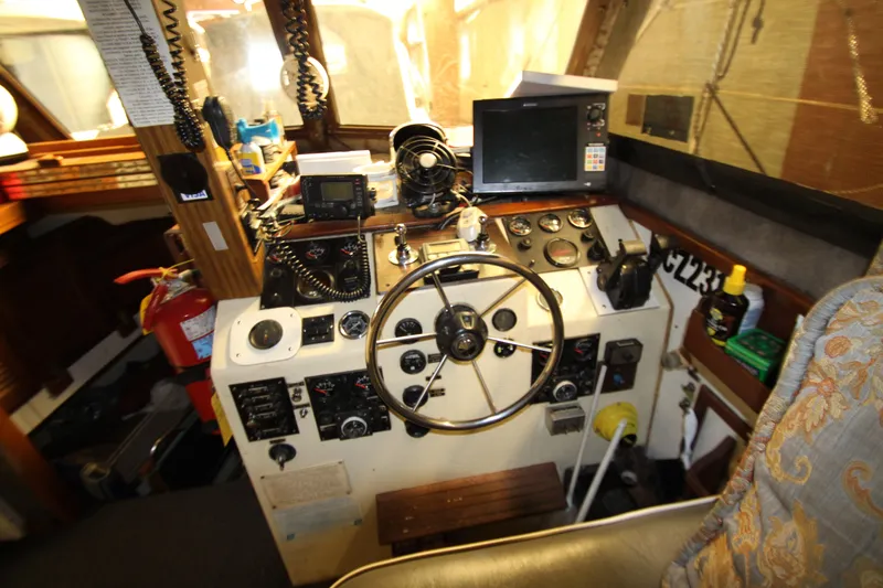 Slide: The Image of Cockpit of 1980 Delta Boatworks 34 Offshore with steering wheel and navigation equipment. - 33