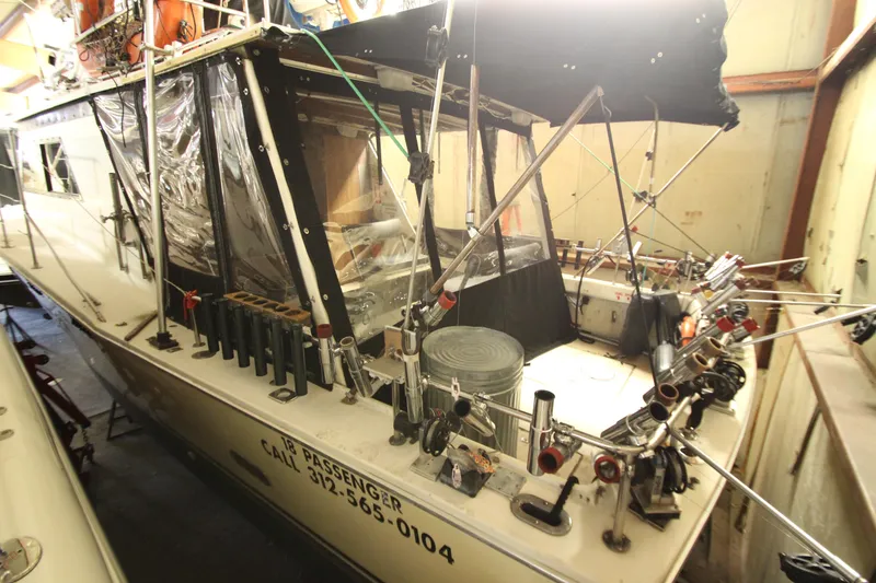 Slide: The Image of 1980 Delta Boatworks 34 Offshore in storage, equipped for fishing, with multiple rod holders. - 4