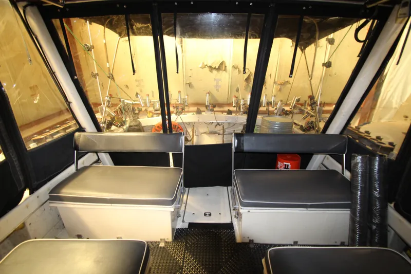 Slide: The Image of Interior of 1980 Delta Boatworks 34 Offshore with seating and fishing equipment. - 9