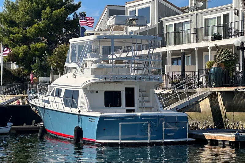 Slide: The Image of 2012 Mikelson 43 Sportfisher yacht docked near waterfront homes. - 1