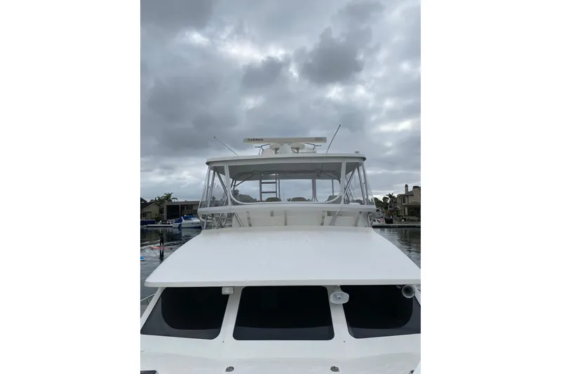 Slide: The Image of 2012 Mikelson 43 Sportfisher boat under cloudy sky, docked in marina. - 10
