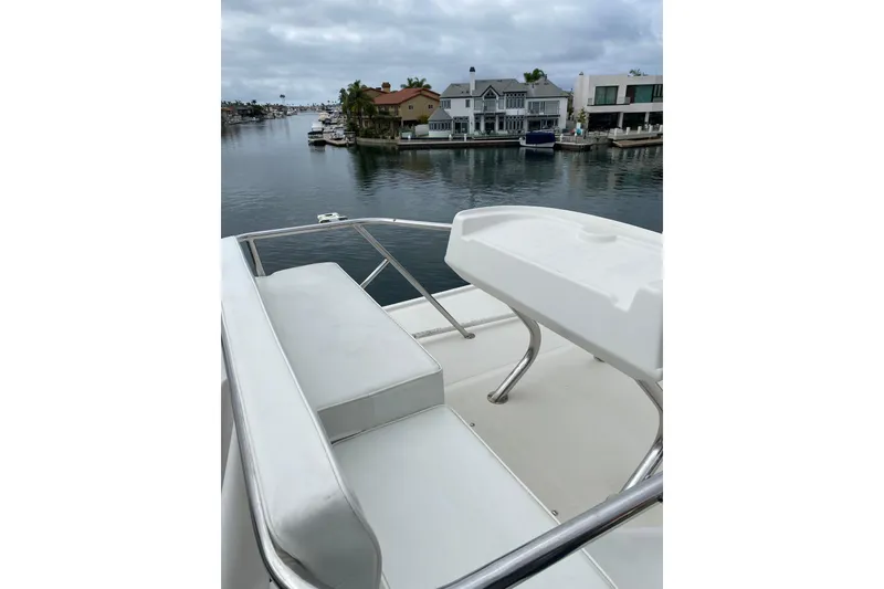 Slide: The Image of 2012 Mikelson 43 Sportfisher yacht with waterfront view and luxurious seating. - 11