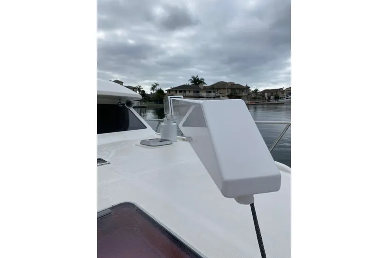 Slide: The Image of 2012 Mikelson 43 Sportfisher boat deck with overcast sky and waterfront view. - 12