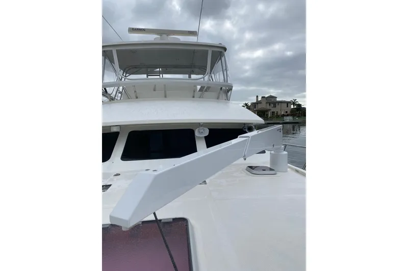 Slide: The Image of 2012 Mikelson 43 Sportfisher yacht with radar, docked under cloudy skies. - 13