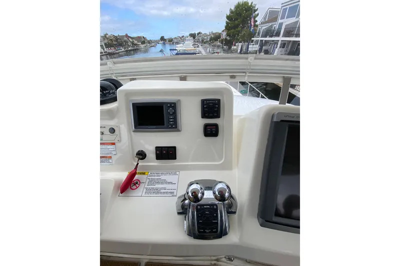 Slide: The Image of Control panel of a 2012 Mikelson 43 Sportfisher with navigation equipment and throttle levers. - 14