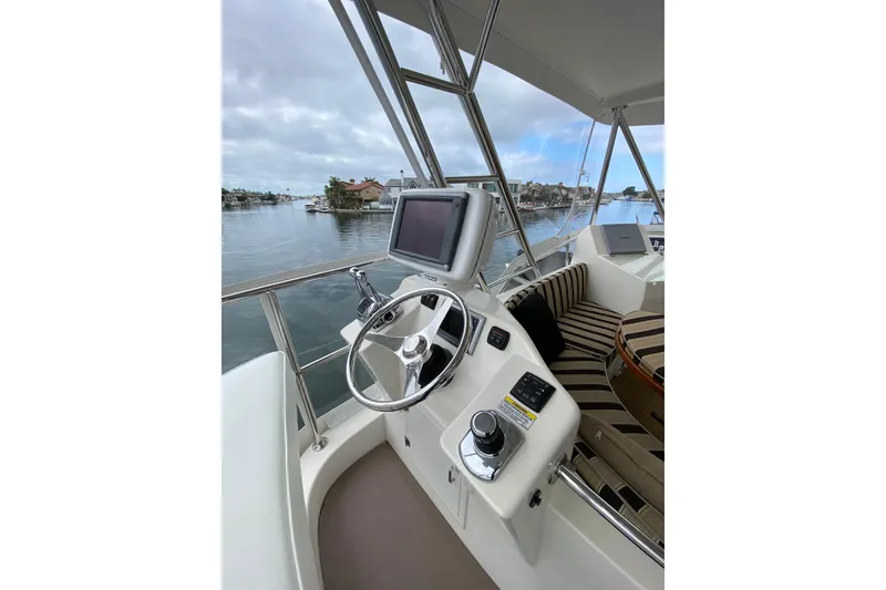 Slide: The Image of Helm of 2012 Mikelson 43 Sportfisher with steering wheel and navigation screen. - 16