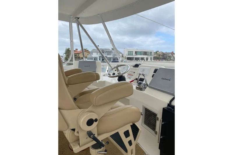 Slide: The Image of Interior view of 2012 Mikelson 43 Sportfisher yacht cockpit with beige seating and navigation equipment. - 19