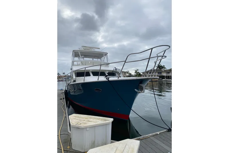 Slide: The Image of 2012 Mikelson 43 Sportfisher yacht docked on a cloudy day. - 2