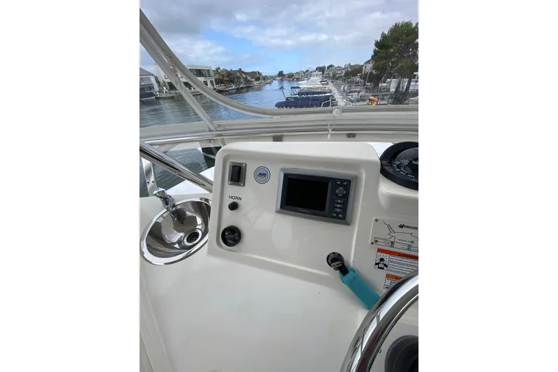 Slide: The Image of Control panel of a 2012 Mikelson 43 Sportfisher boat with waterway view. - 21
