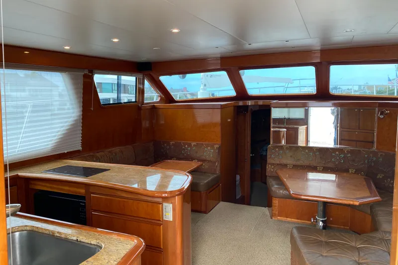 Slide: The Image of Luxurious interior of 2012 Mikelson 43 Sportfisher yacht with wood finishes and seating area. - 25