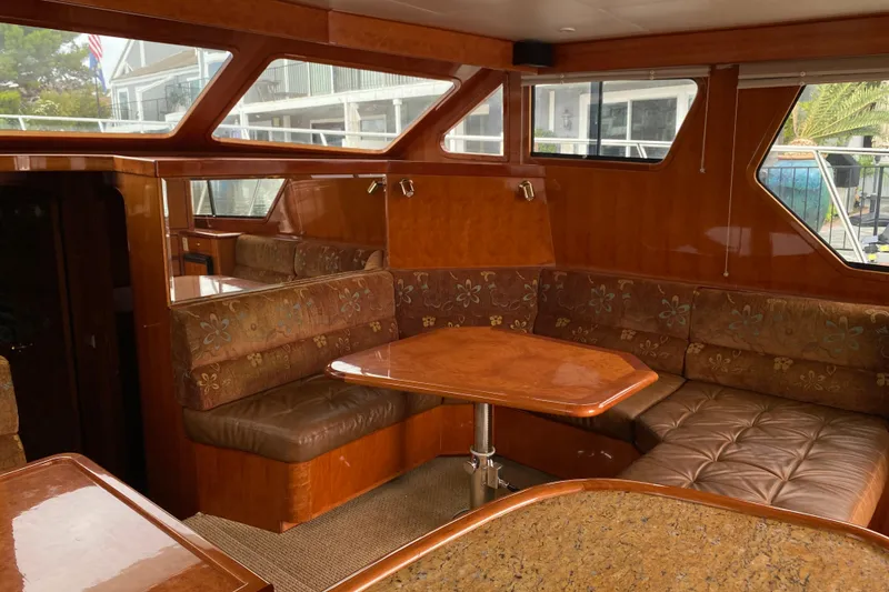 Slide: The Image of Luxurious interior of 2012 Mikelson 43 Sportfisher yacht with plush seating and wooden table. - 26
