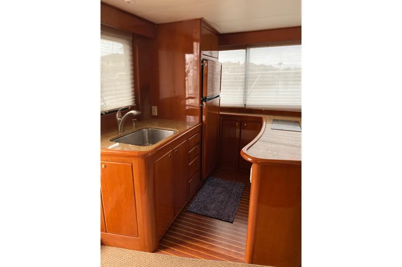 Slide: The Image of Luxurious kitchen interior of 2012 Mikelson 43 Sportfisher yacht with wood cabinetry. - 28
