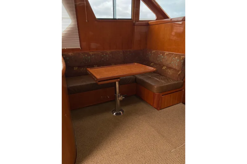 Slide: The Image of Interior of 2012 Mikelson 43 Sportfisher with wooden table and cushioned seating. - 31