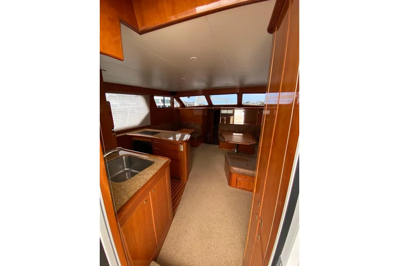 Slide: The Image of Interior of 2012 Mikelson 43 Sportfisher yacht with wood finishes and modern amenities. - 32