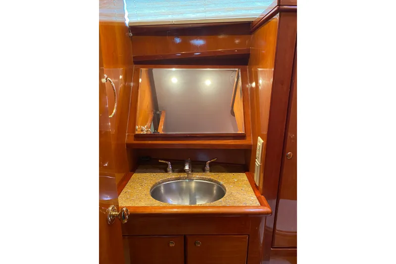 Slide: The Image of Luxurious wooden vanity with sink in 2012 Mikelson 43 Sportfisher yacht bathroom. - 35