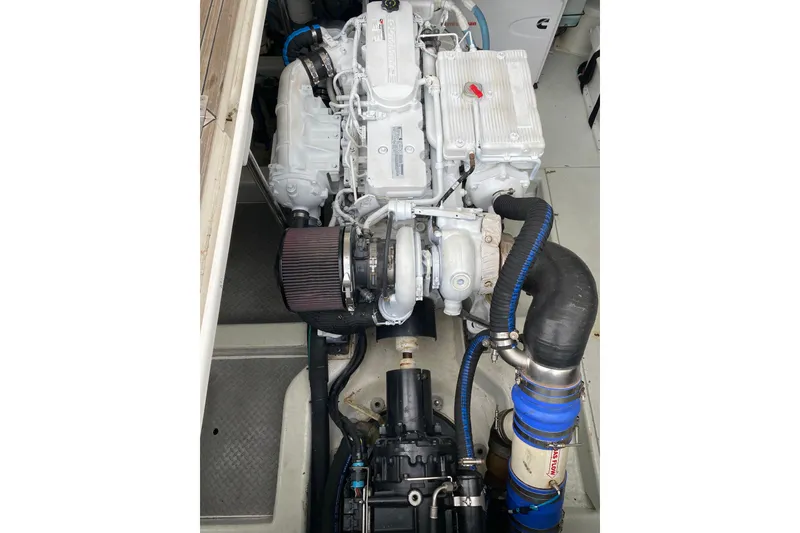 Slide: The Image of Engine compartment of a 2012 Mikelson 43 Sportfisher boat, showcasing detailed machinery. - 43