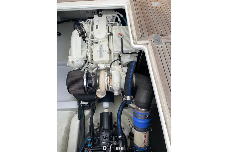 Slide: The Image of Engine compartment of 2012 Mikelson 43 Sportfisher with visible components and hoses. - 44