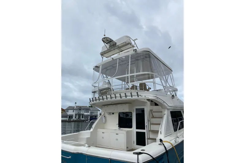 Slide: The Image of 2012 Mikelson 43 Sportfisher yacht docked under cloudy skies. - 5