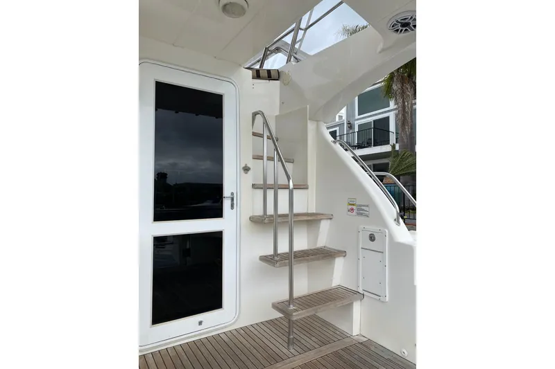 Slide: The Image of Stainless steel stairs on 2012 Mikelson 43 Sportfisher yacht, leading to upper deck. - 6