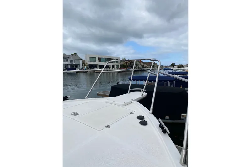 Slide: The Image of 2012 Mikelson 43 Sportfisher docked, showcasing bow and waterfront view. - 7