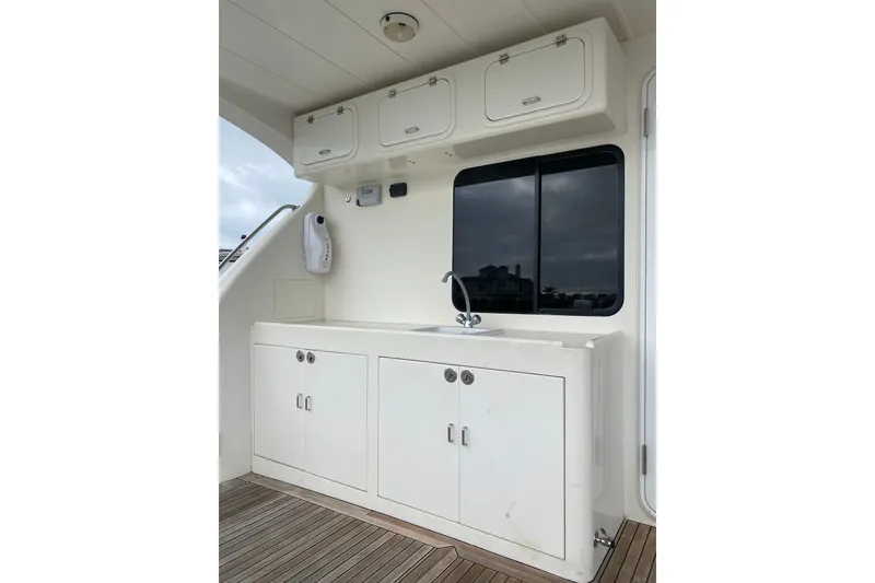 Slide: The Image of 2012 Mikelson 43 Sportfisher yacht interior with white cabinetry and sink. - 8