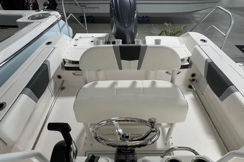 Slide: The Image of 2026 Robalo R200 Center Console boat interior with steering wheel and seating. - 8