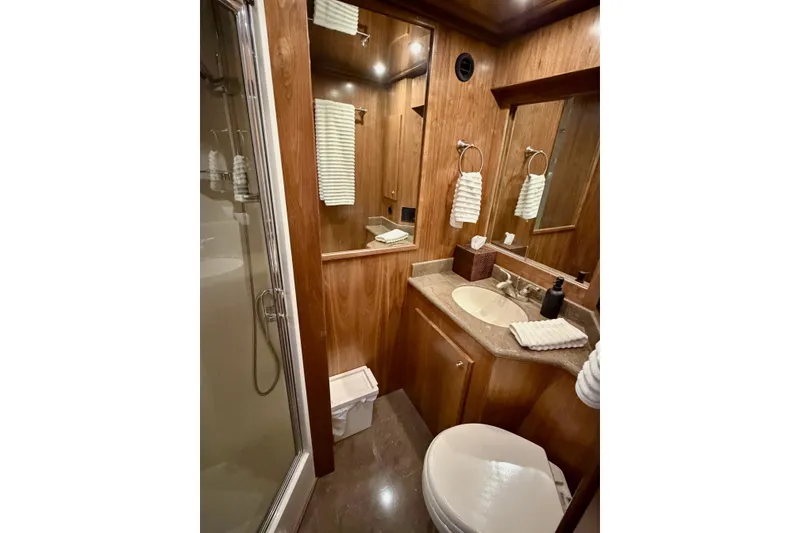 Slide: The Image of Luxurious bathroom in 2009 Navigator California 50 Veneti yacht with wood accents and modern fixtures. - 12