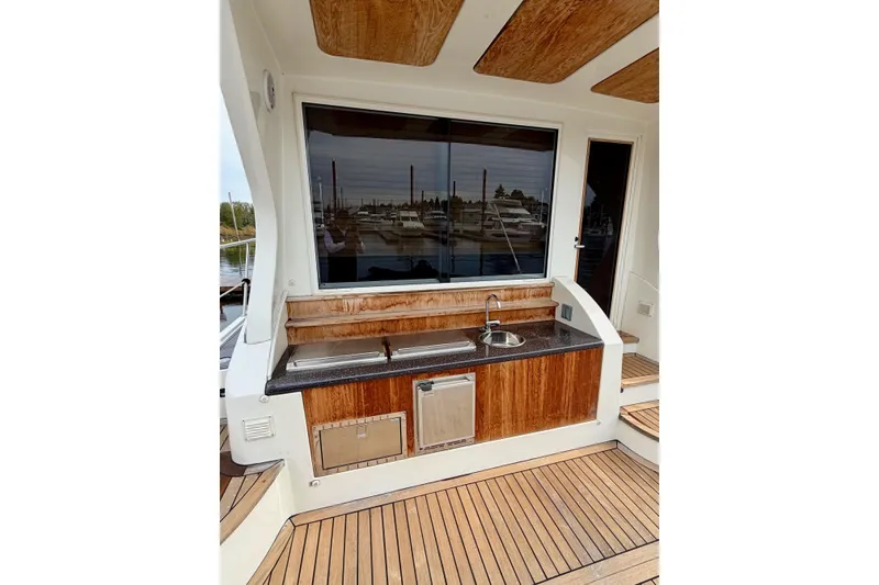 Slide: The Image of Outdoor kitchen on 2009 Navigator California 50 Veneti yacht with wood accents and sink. - 15