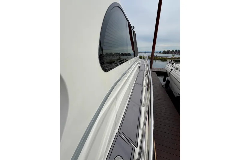 Slide: The Image of Side view of 2009 Navigator California 50 Veneti yacht docked by the water. - 18