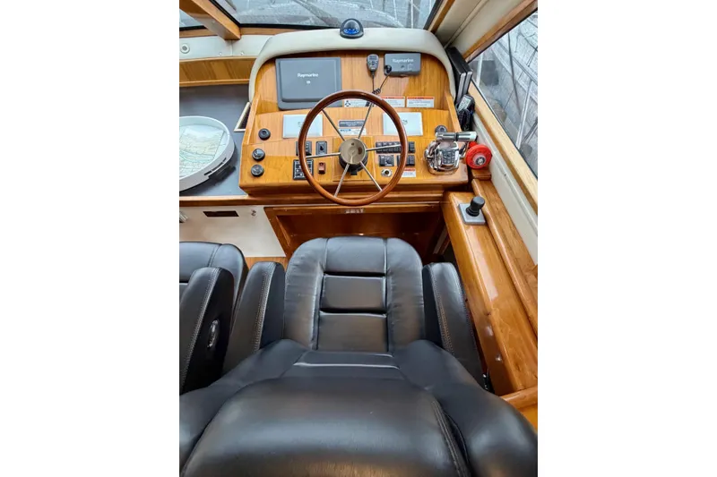 Slide: The Image of Helm of 2009 Navigator California 50 Veneti yacht with wooden steering wheel and navigation equipment. - 19