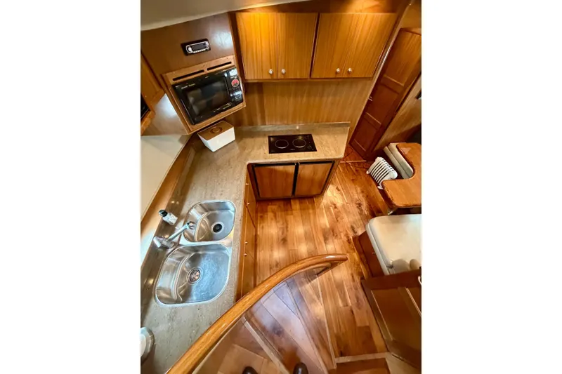 Slide: The Image of Luxurious kitchen interior of 2009 Navigator California 50 Veneti yacht with wood finish. - 20