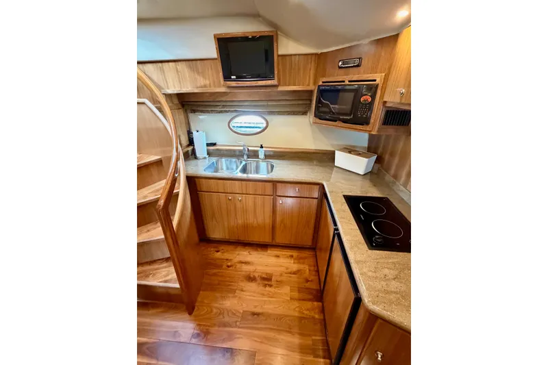 Slide: The Image of Luxurious kitchen in 2009 Navigator California 50 Veneti yacht with wood cabinetry and modern appliances. - 21
