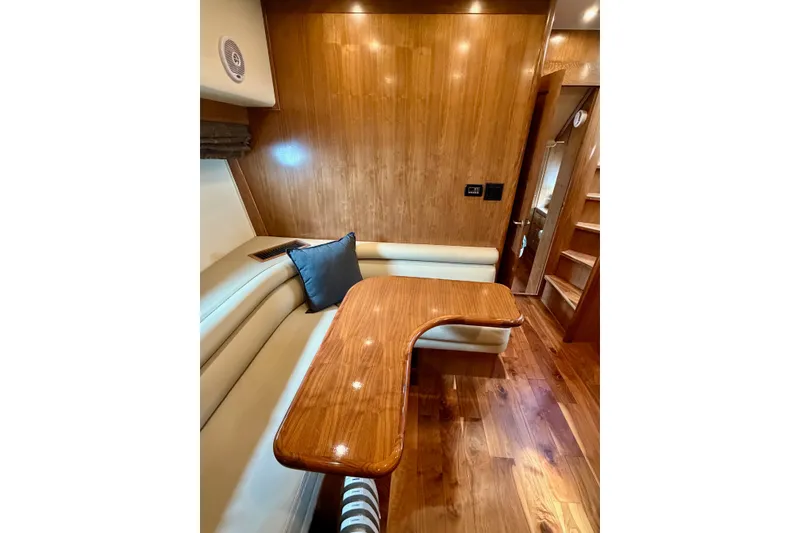 Slide: The Image of Luxurious interior of 2009 Navigator California 50 Veneti yacht with wooden table and seating. - 22
