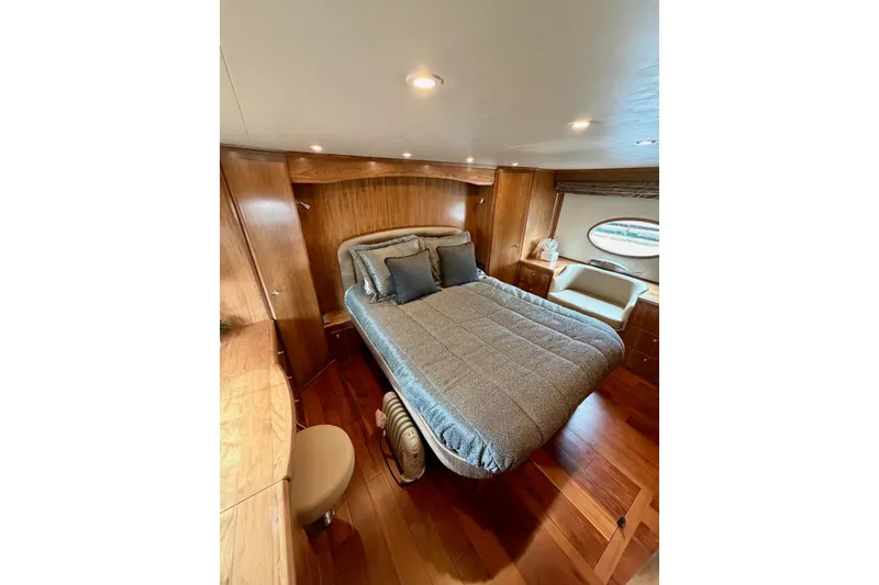 Slide: The Image of Luxurious bedroom interior of 2009 Navigator California 50 Veneti yacht with wood accents. - 26