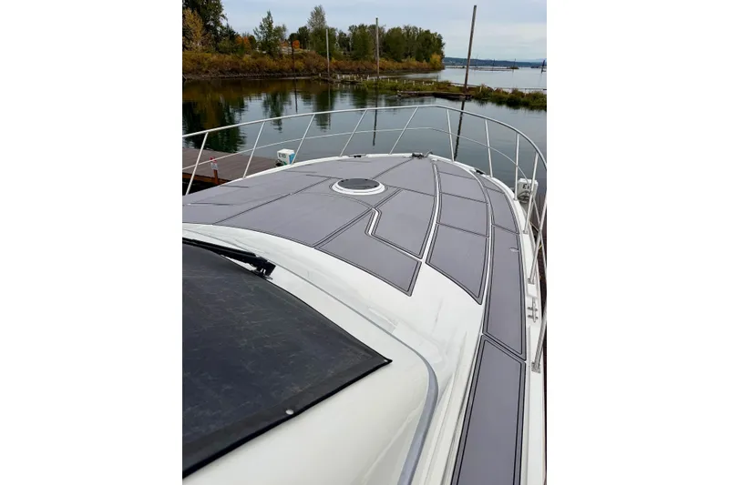 Slide: The Image of 2009 Navigator California 50 Veneti yacht deck, docked by a serene waterfront. - 4