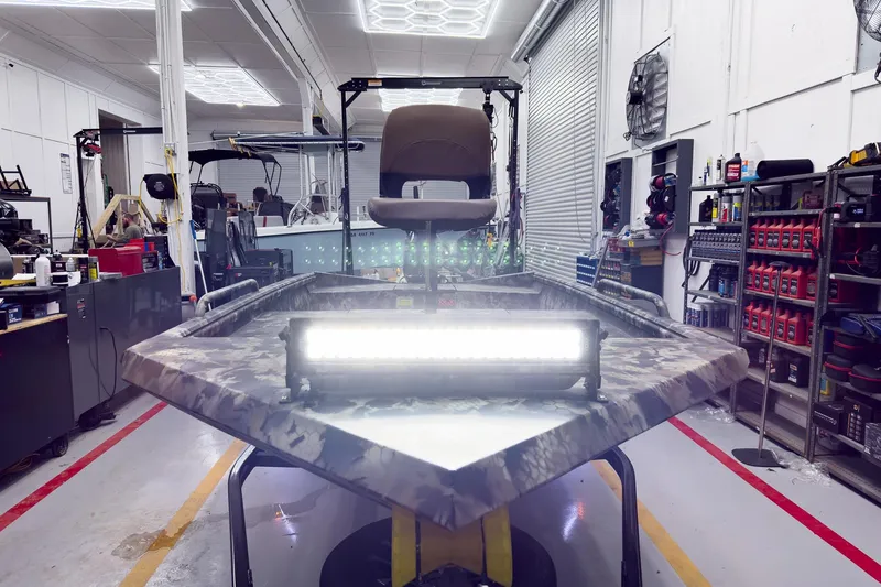 Slide: The Image of 2026 Excel Eclipse boat in workshop with LED light bar and camo design. - 16